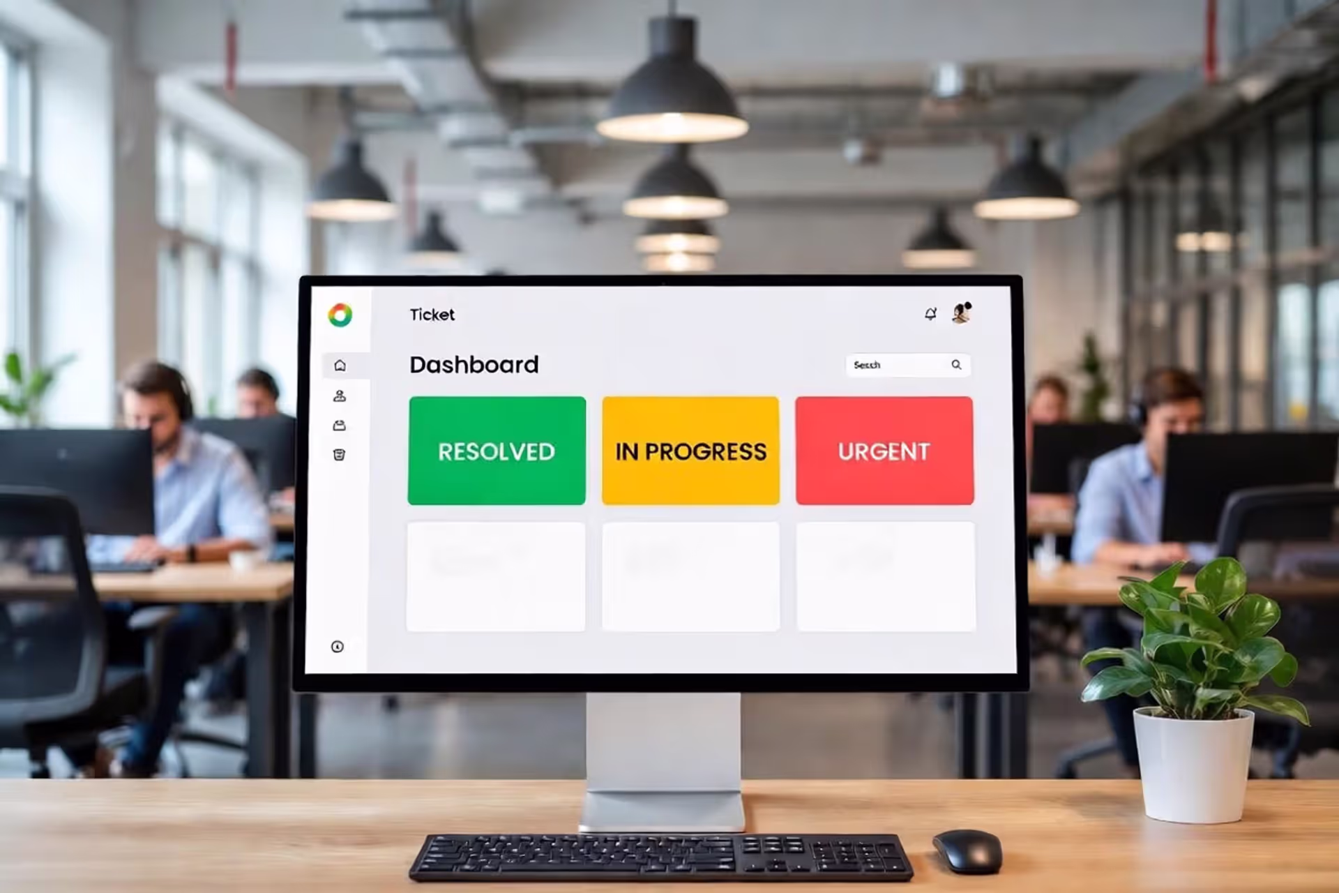 Modern IT department open-space office with a large monitor displaying a ticketing system dashboard with colorful status cards, support team members working at laptops in the background